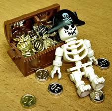 photo of Lego pirate skeleton leaning on a treasure chest.